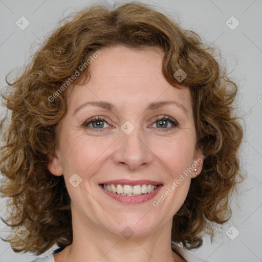 Joyful white adult female with medium  brown hair and blue eyes