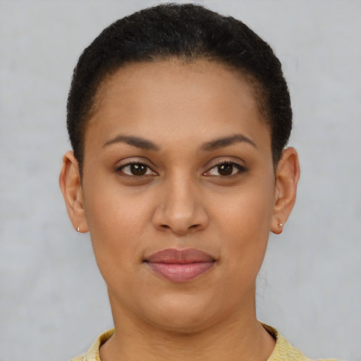 Joyful latino young-adult female with short  brown hair and brown eyes