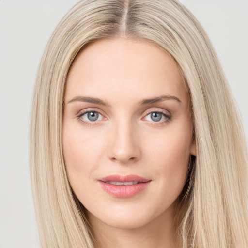 Joyful white young-adult female with long  brown hair and blue eyes