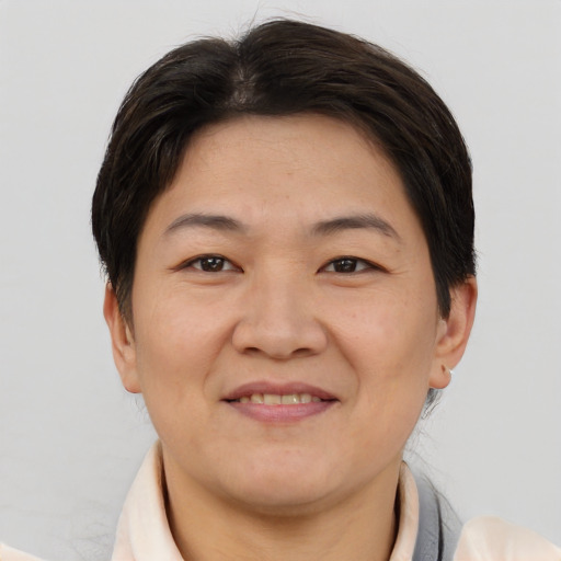 Joyful asian adult male with short  brown hair and brown eyes
