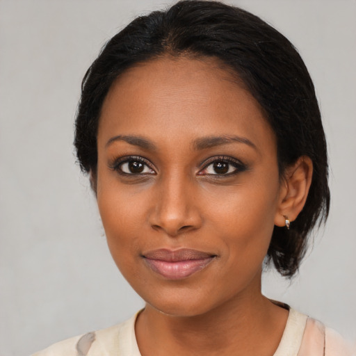 Joyful black young-adult female with medium  black hair and brown eyes