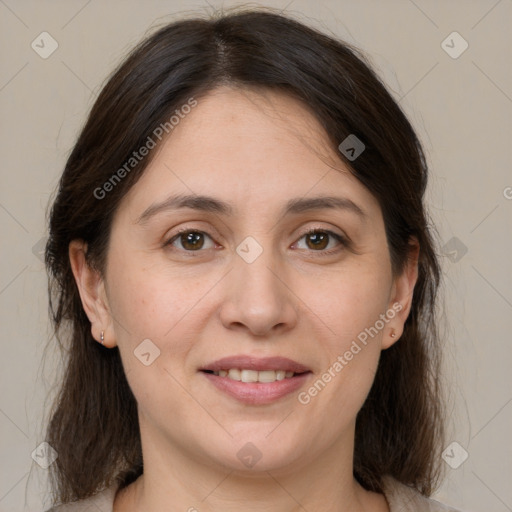 Joyful white adult female with medium  brown hair and brown eyes