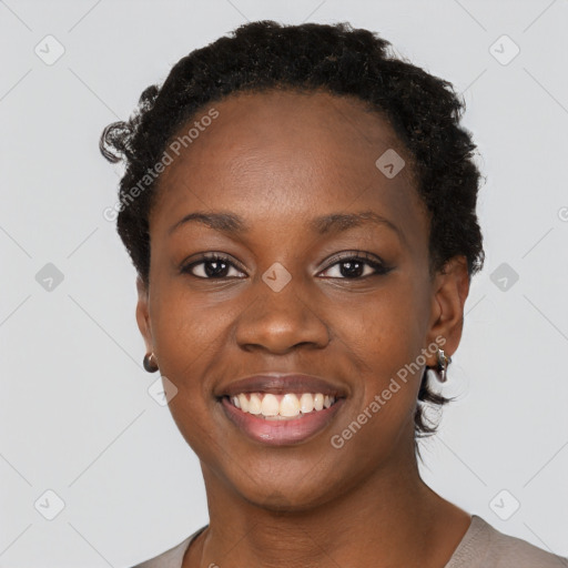 Joyful black young-adult female with short  black hair and brown eyes