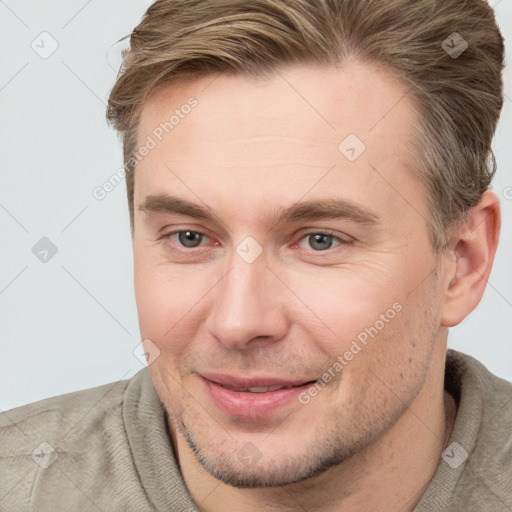 Joyful white adult male with short  brown hair and brown eyes