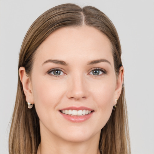 Joyful white young-adult female with long  brown hair and grey eyes