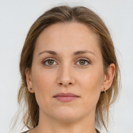 Joyful white young-adult female with medium  brown hair and grey eyes