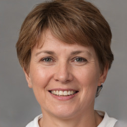 Joyful white adult female with medium  brown hair and brown eyes