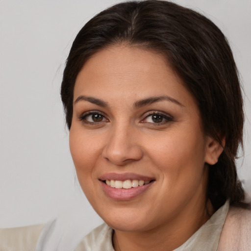 Joyful white young-adult female with medium  brown hair and brown eyes