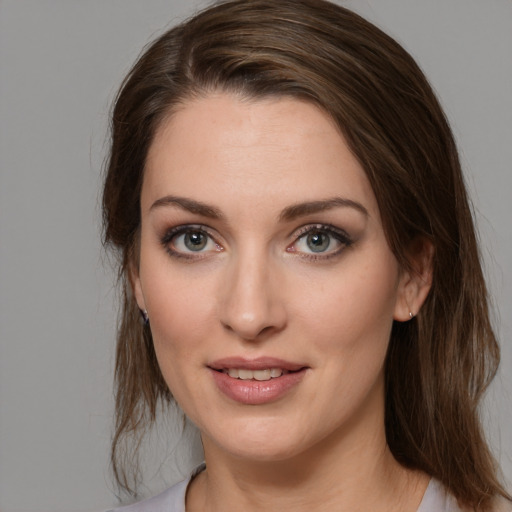 Joyful white young-adult female with medium  brown hair and brown eyes