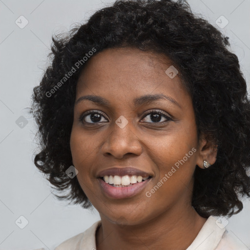 Joyful black young-adult female with long  brown hair and brown eyes