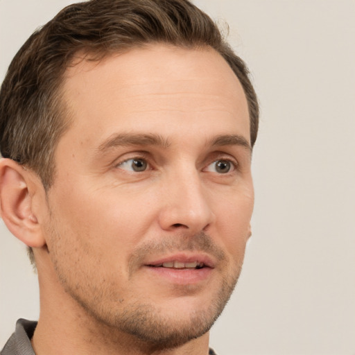 Joyful white adult male with short  brown hair and grey eyes