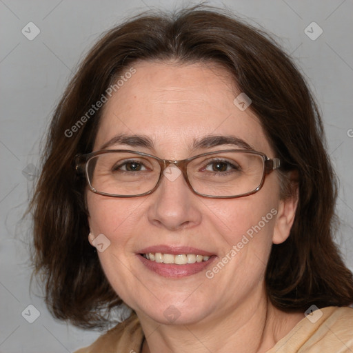 Joyful white adult female with medium  brown hair and blue eyes