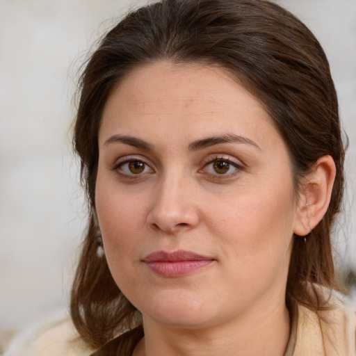 Joyful white young-adult female with long  brown hair and brown eyes