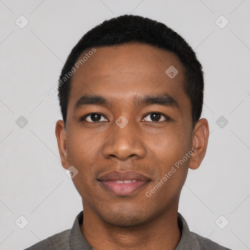 Joyful black young-adult male with short  black hair and brown eyes