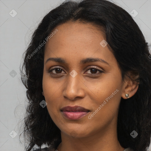 Joyful black young-adult female with long  black hair and brown eyes