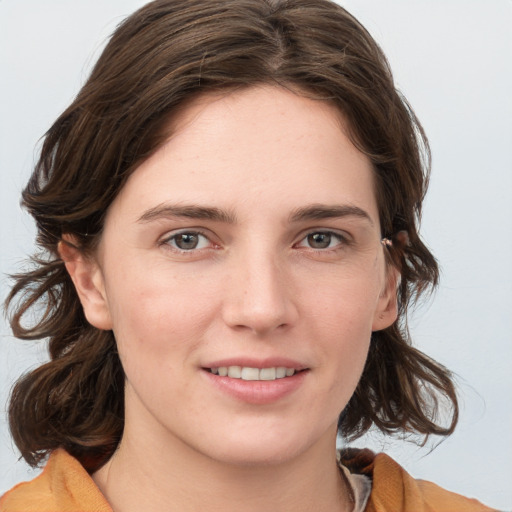 Joyful white young-adult female with medium  brown hair and blue eyes