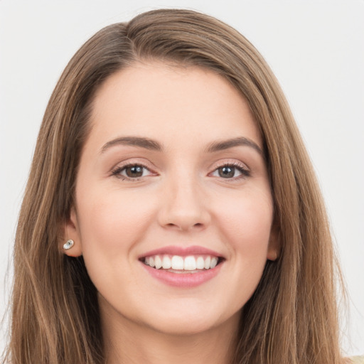 Joyful white young-adult female with long  brown hair and grey eyes