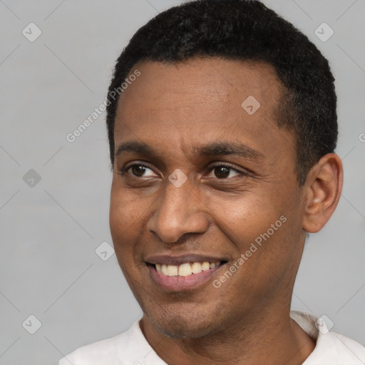 Joyful latino young-adult male with short  black hair and brown eyes