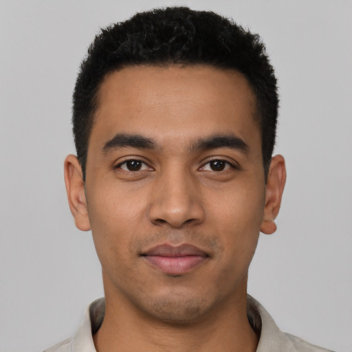 Joyful latino young-adult male with short  black hair and brown eyes