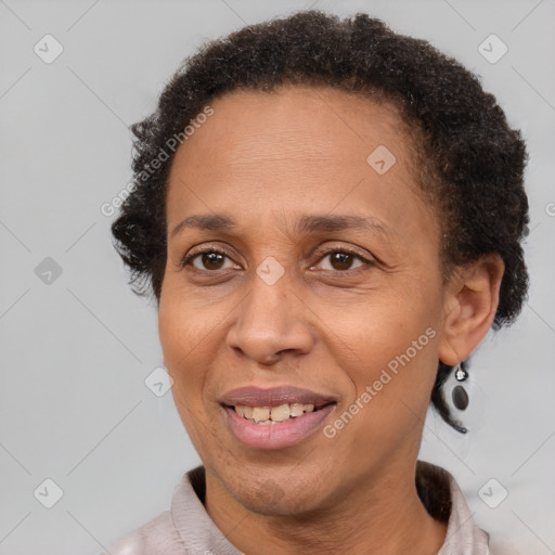 Joyful black adult female with short  brown hair and brown eyes