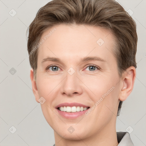 Joyful white young-adult female with short  brown hair and grey eyes