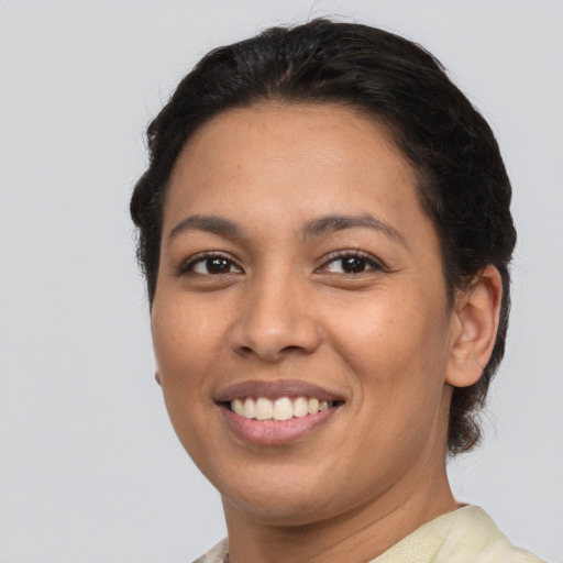 Joyful latino young-adult female with short  brown hair and brown eyes