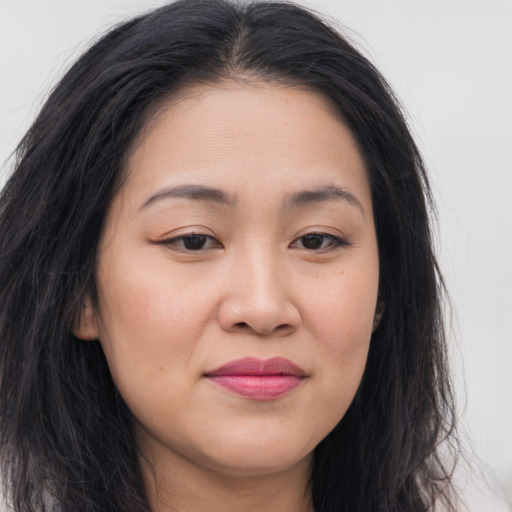 Joyful asian young-adult female with long  brown hair and brown eyes