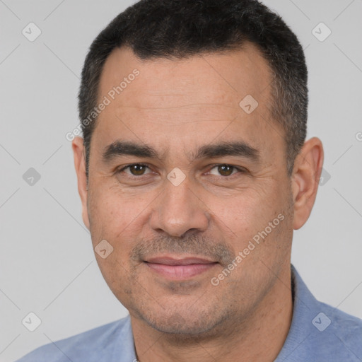 Joyful white adult male with short  black hair and brown eyes