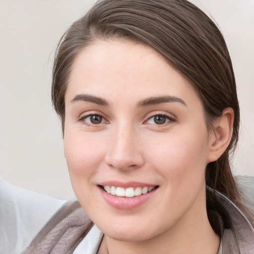 Joyful white young-adult female with medium  brown hair and grey eyes