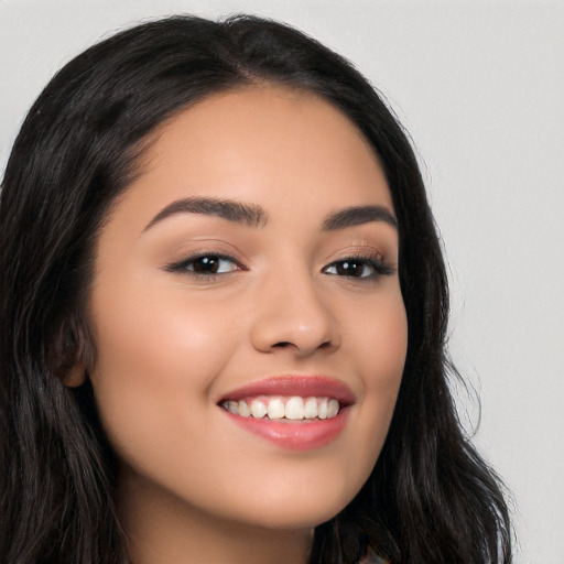 Joyful latino young-adult female with long  black hair and brown eyes