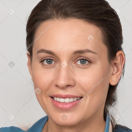 Joyful white adult female with medium  brown hair and grey eyes