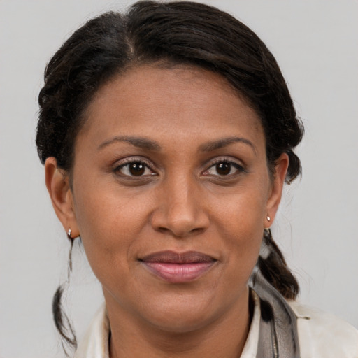 Joyful latino adult female with medium  brown hair and brown eyes