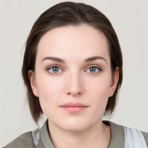 Neutral white young-adult female with medium  brown hair and grey eyes