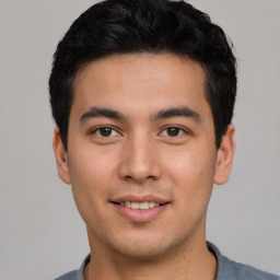 Joyful asian young-adult male with short  black hair and brown eyes