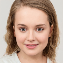 Joyful white child female with medium  brown hair and grey eyes