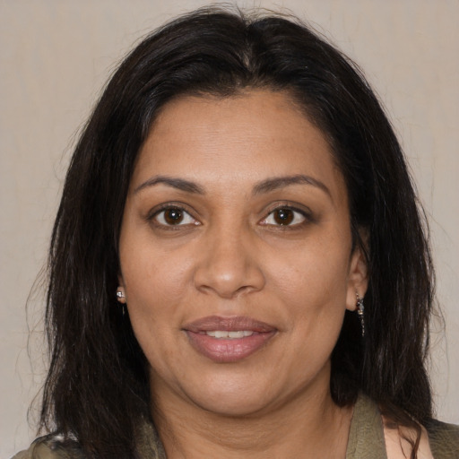 Joyful black adult female with medium  brown hair and brown eyes