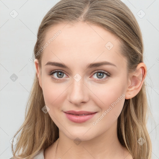 Joyful white young-adult female with long  brown hair and blue eyes