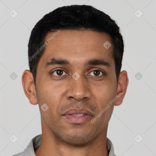 Joyful latino young-adult male with short  black hair and brown eyes