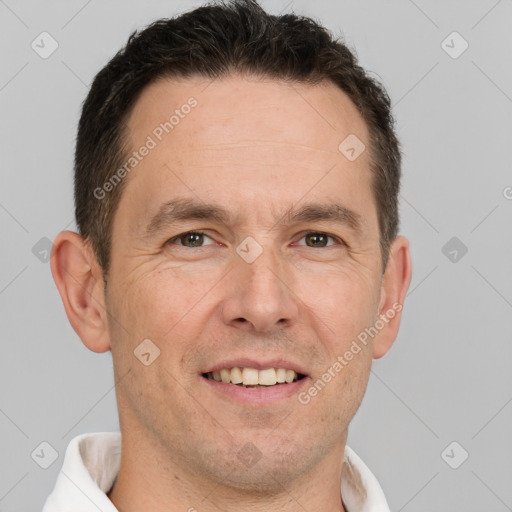 Joyful white adult male with short  brown hair and brown eyes