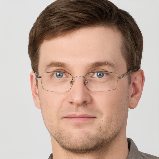 Joyful white adult male with short  brown hair and grey eyes