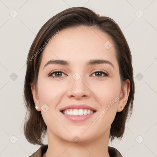 Joyful white young-adult female with medium  brown hair and grey eyes