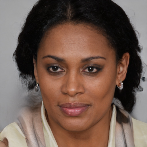 Joyful black adult female with medium  brown hair and brown eyes