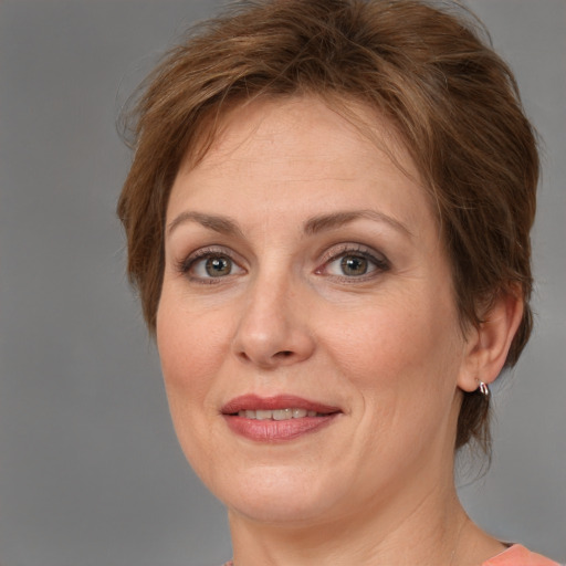 Joyful white adult female with medium  brown hair and grey eyes