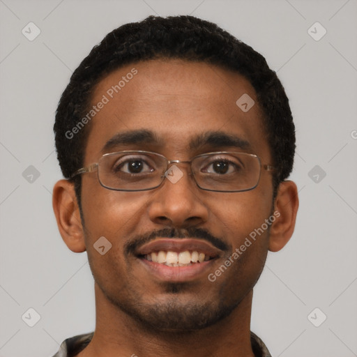 Joyful black young-adult male with short  black hair and brown eyes
