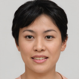 Joyful asian young-adult female with short  brown hair and brown eyes