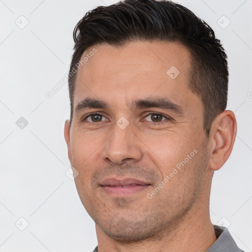 Joyful white adult male with short  brown hair and brown eyes