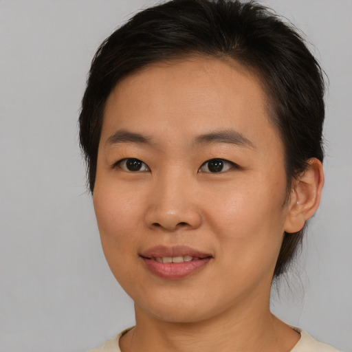 Joyful asian young-adult female with medium  brown hair and brown eyes