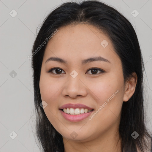 Joyful asian young-adult female with long  brown hair and brown eyes