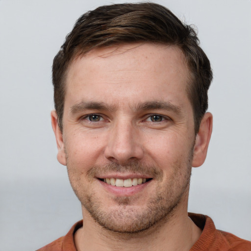 Joyful white young-adult male with short  brown hair and brown eyes