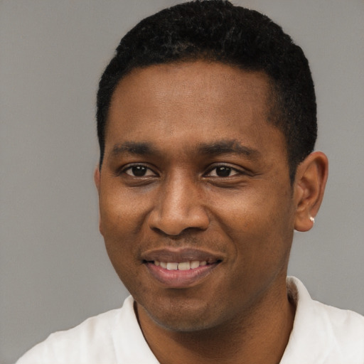 Joyful black young-adult male with short  black hair and brown eyes